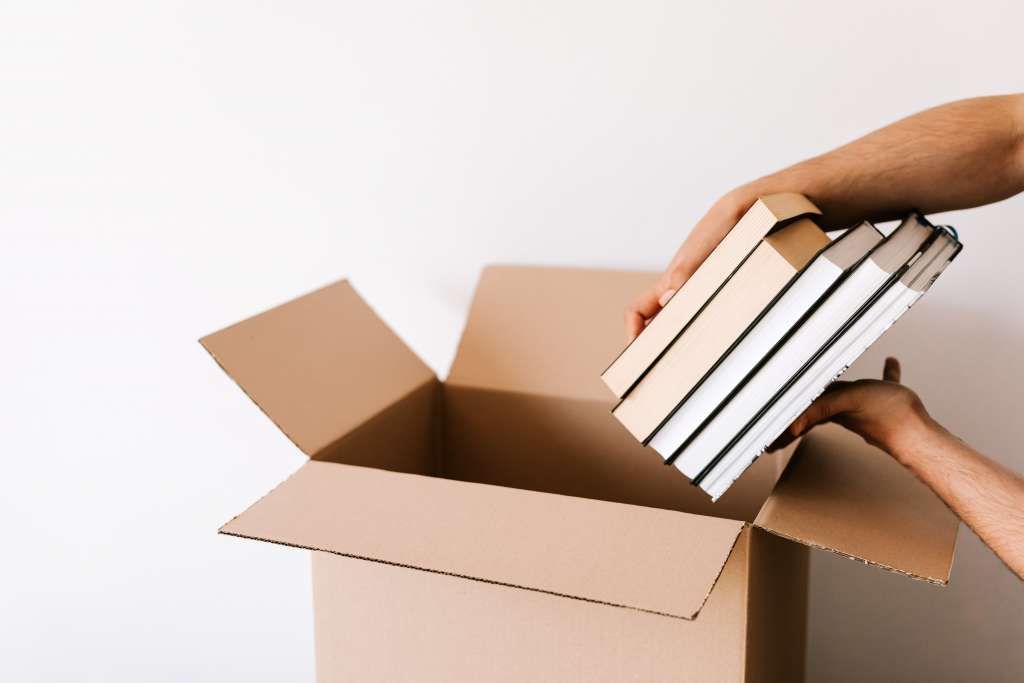 put the book in the cardboard box