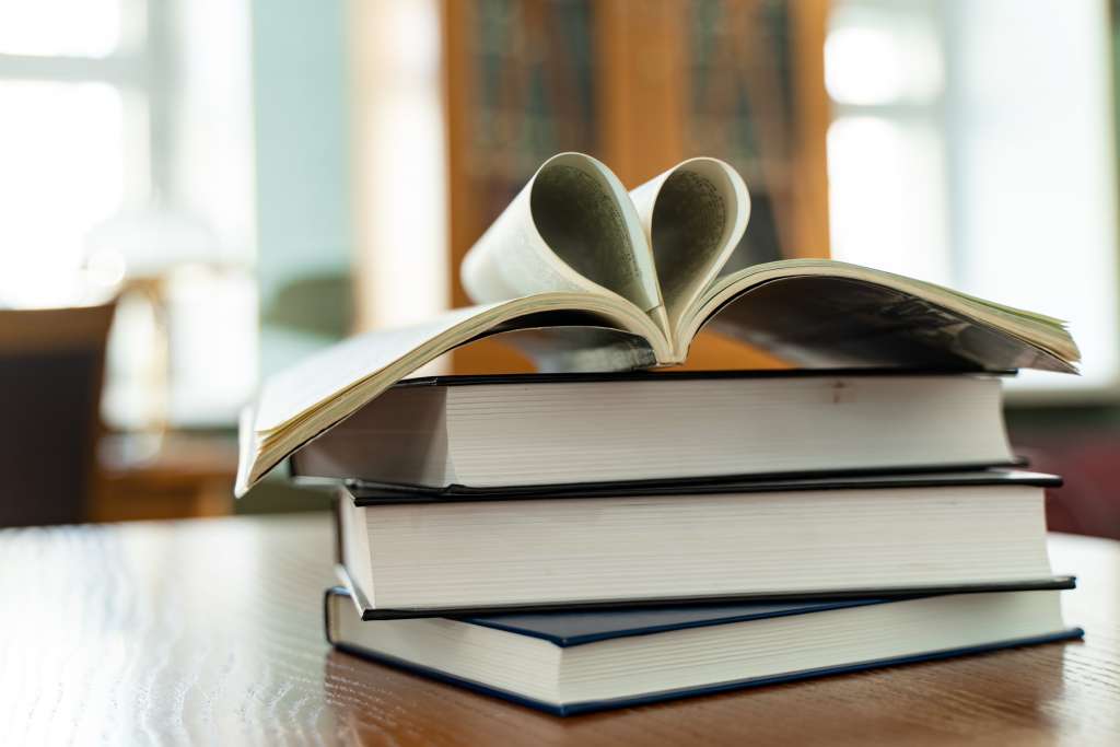 open book on top of several stacked books