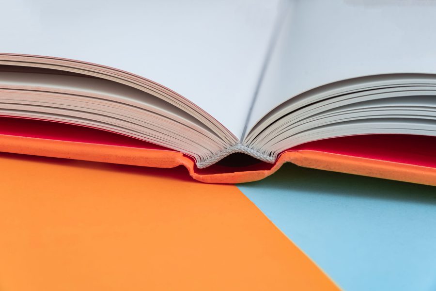 Physical paper book over background – closeup print and bind a book